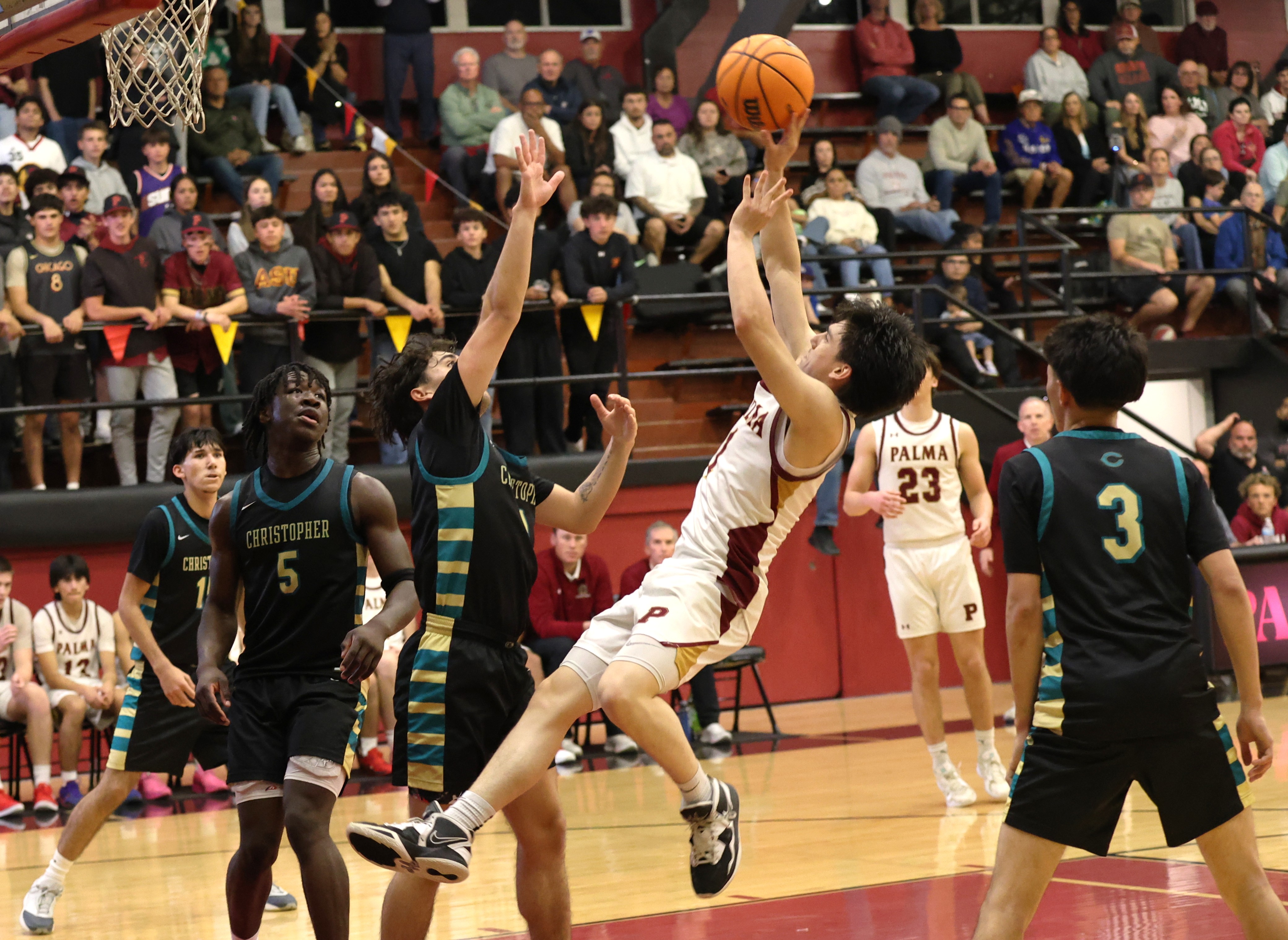 Palma’s Tai Suich attempts an acrobatic shot late in the fourth quarter in the Chieftains’ 73-59 win Tuesday night in the Northern California Division III playoffs at Palma. Suich finished with 20 points and Palma advanced for a road game at Cornerstone Christian on Thursday. (Donald Fukui -- Monterey Herald)